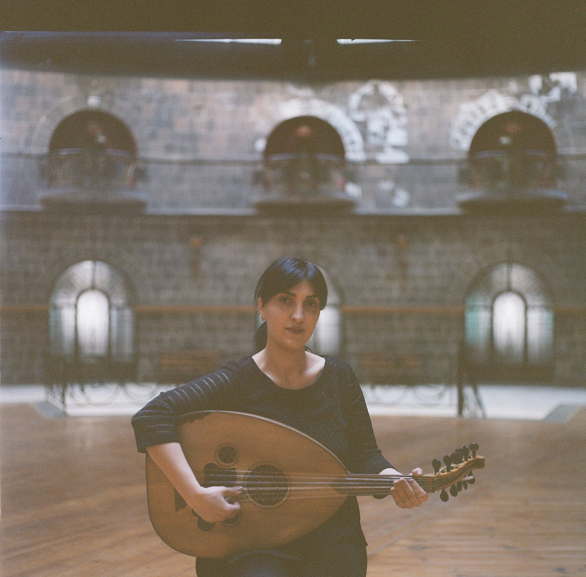A musician seated with an oud